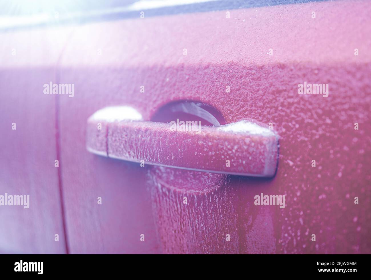 Frozen car door handle. Closeup of car door handle and lock covered in