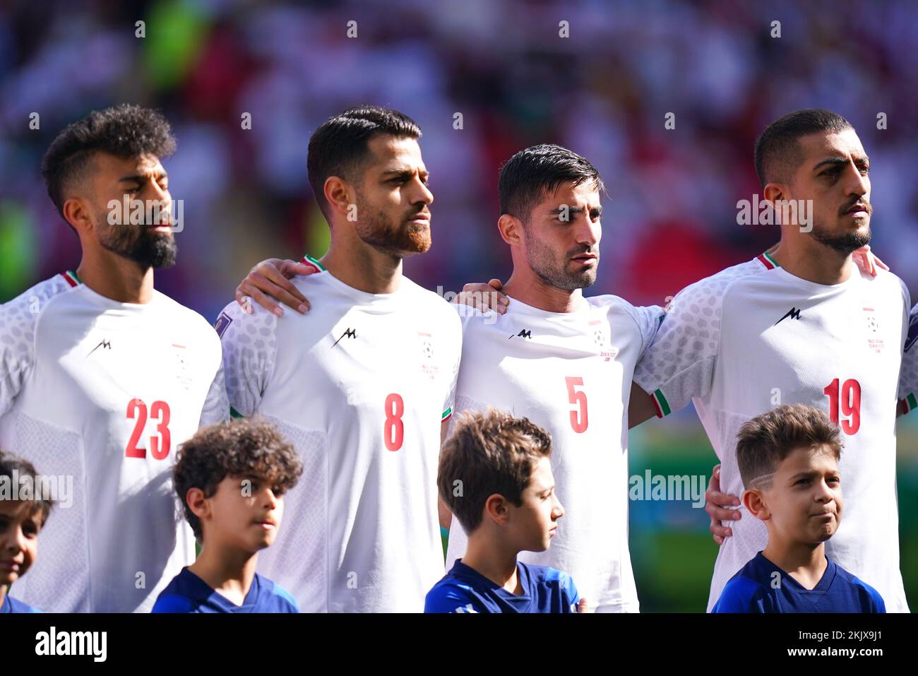 Iran's Ramin Rezaeian (left), Morteza Pouraliganji, Milad Mohammadi and Majid Hosseini during their national anthem ahead of the FIFA World Cup Group B match at the Ahmad Bin Ali Stadium, Al-Rayyan. Picture date: Friday November 25, 2022. Stock Photo