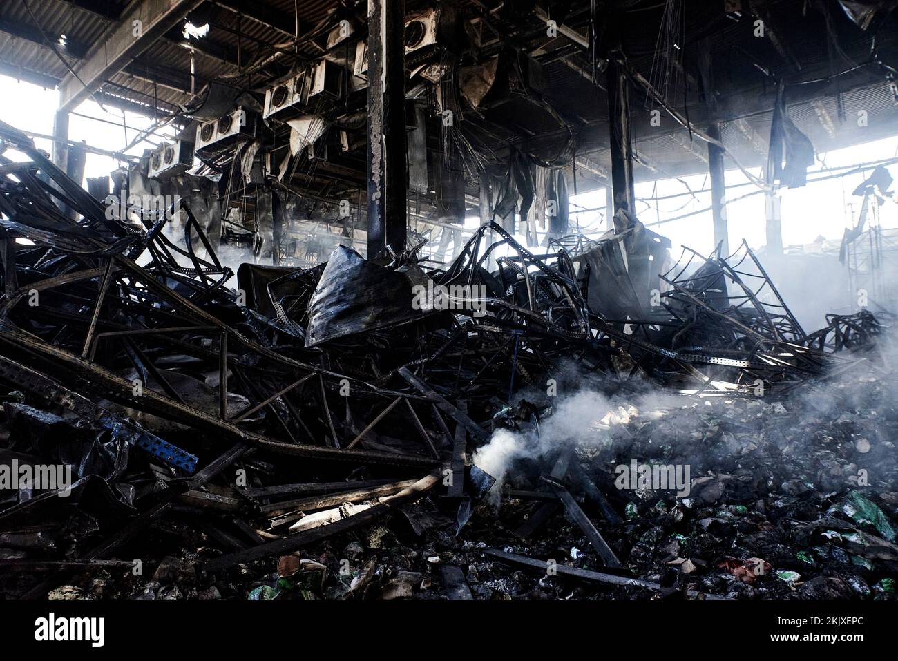Antonin Burat / Le Pictorium -  War in Ukraine: David stands up to Goliath -  29/3/2022  -  Ukraine / Kyiv  -  Inside the smoking ruins of a warehouse Stock Photo