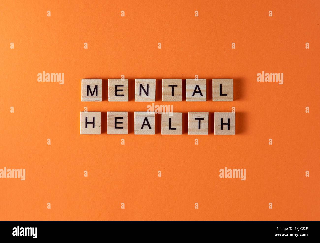 mental-health-word-phrase-in-wooden-letters-motivation-and-slogan-orange-background-stock