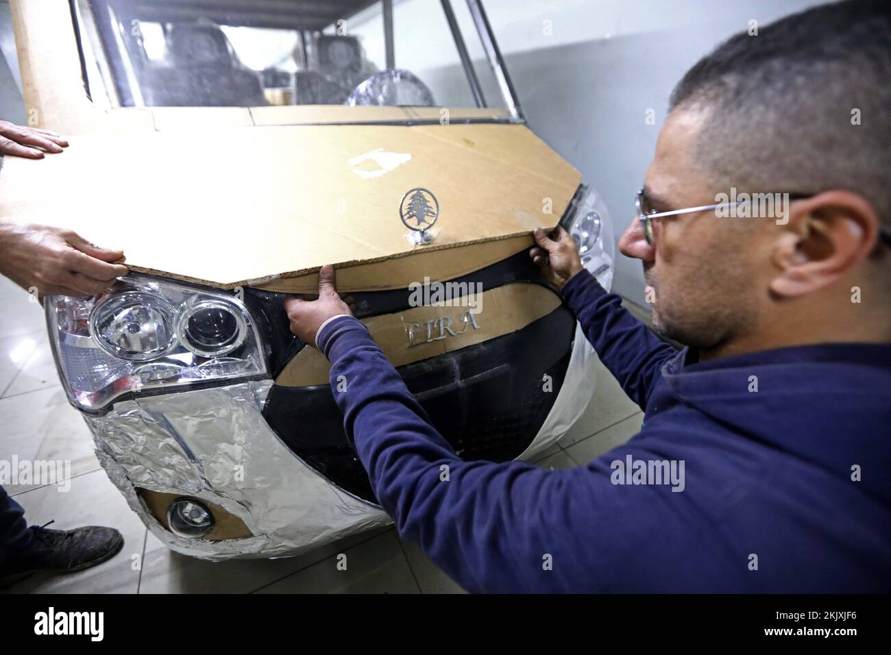 (221125) -- BEIRUT, Nov. 25, 2022 (Xinhua) -- A mechanic works on a hybrid vehicle designed by Hisham Houssami in Beirut, Lebanon, Nov. 21, 2022. TO GO WITH 'Feature: Lebanese invent new energy car to cope with energy crisis' (Xinhua/Bilal Jawich) Stock Photo