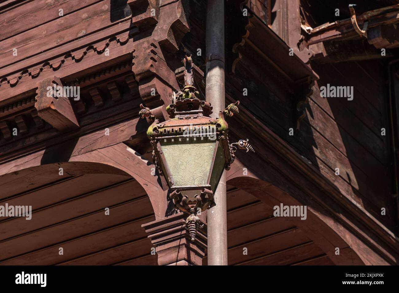 Intricate baroque outside lantern made of metal and glass with
