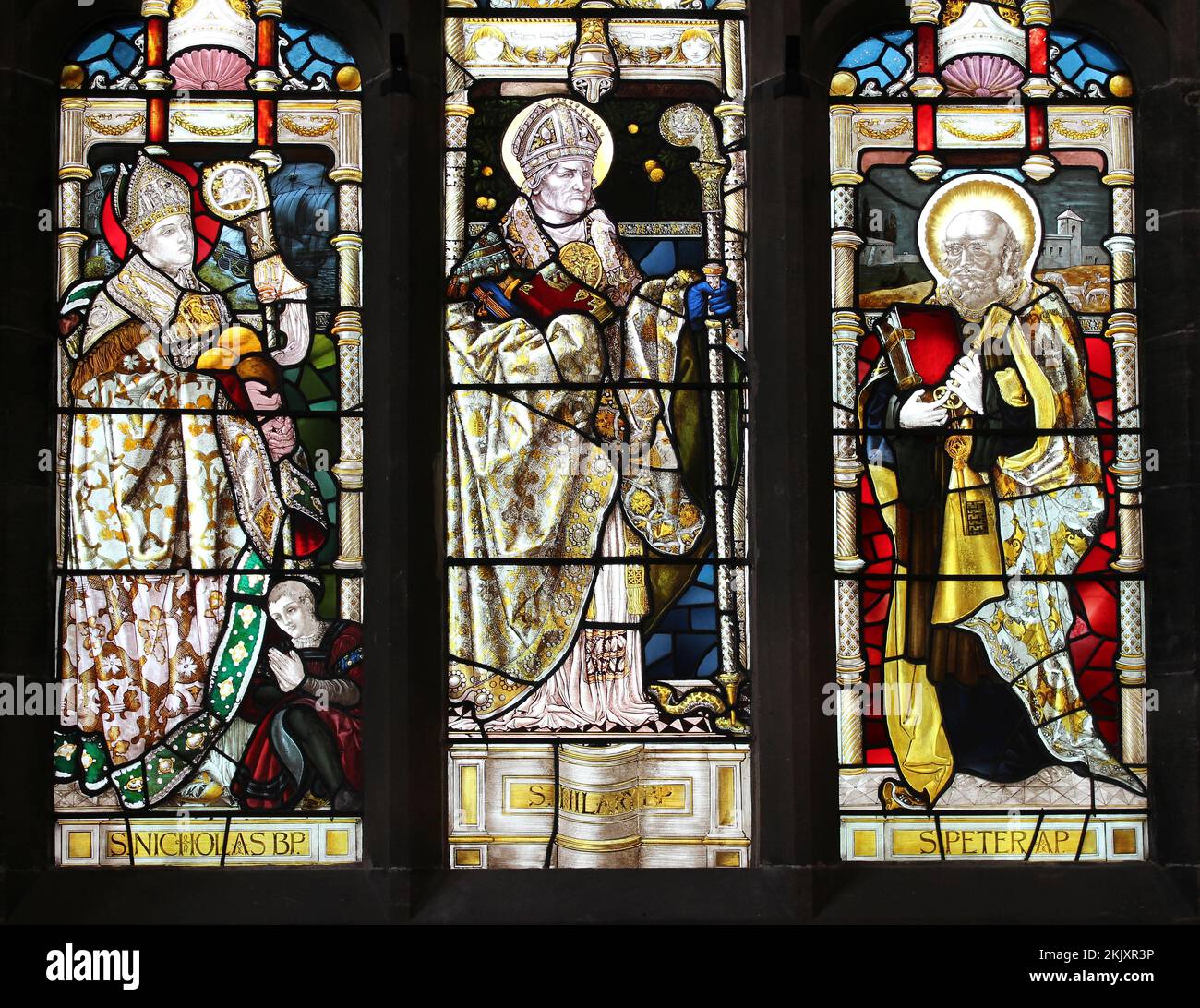St Hilary's Church, Wallasey UK - Three Saints Stained Glass Window Stock Photo