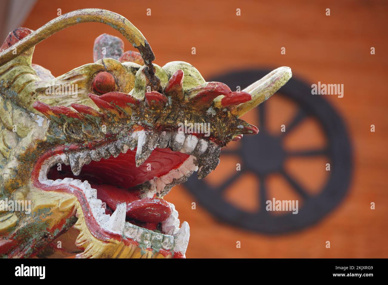 A closeup of the head of an old Chinese dragon sculpture. Stock Photo