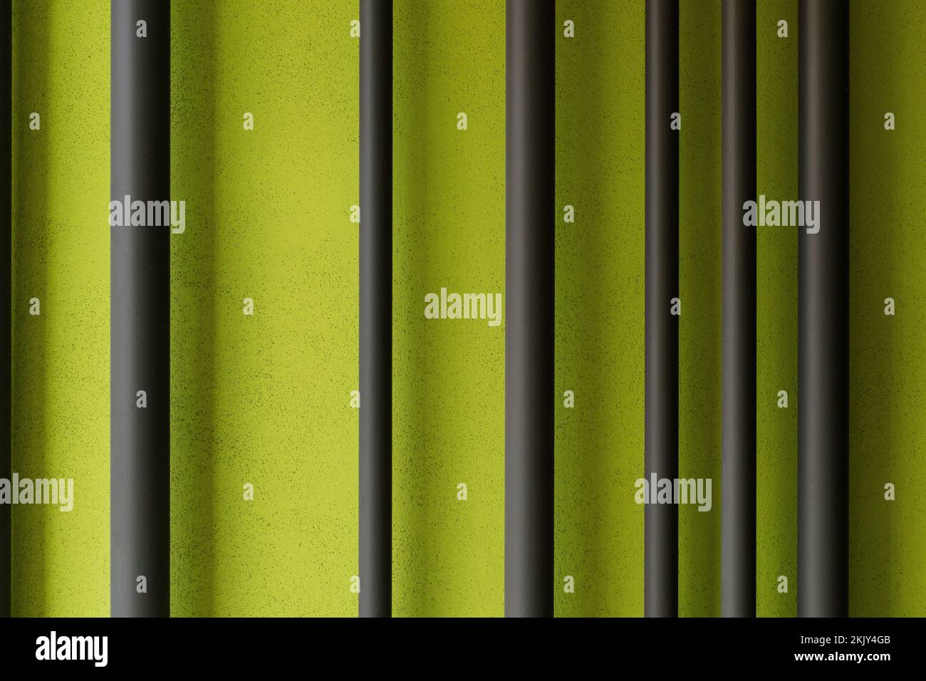 Black metallic fence texture closeup on green background. Background texture Stock Photo