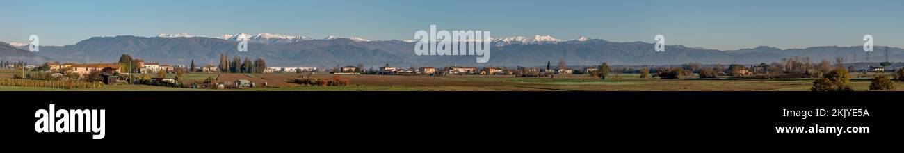 Panoramic view of the partially snow-capped Apennines from the Tuscan countryside near Bientina, Pisa , Italy Stock Photo