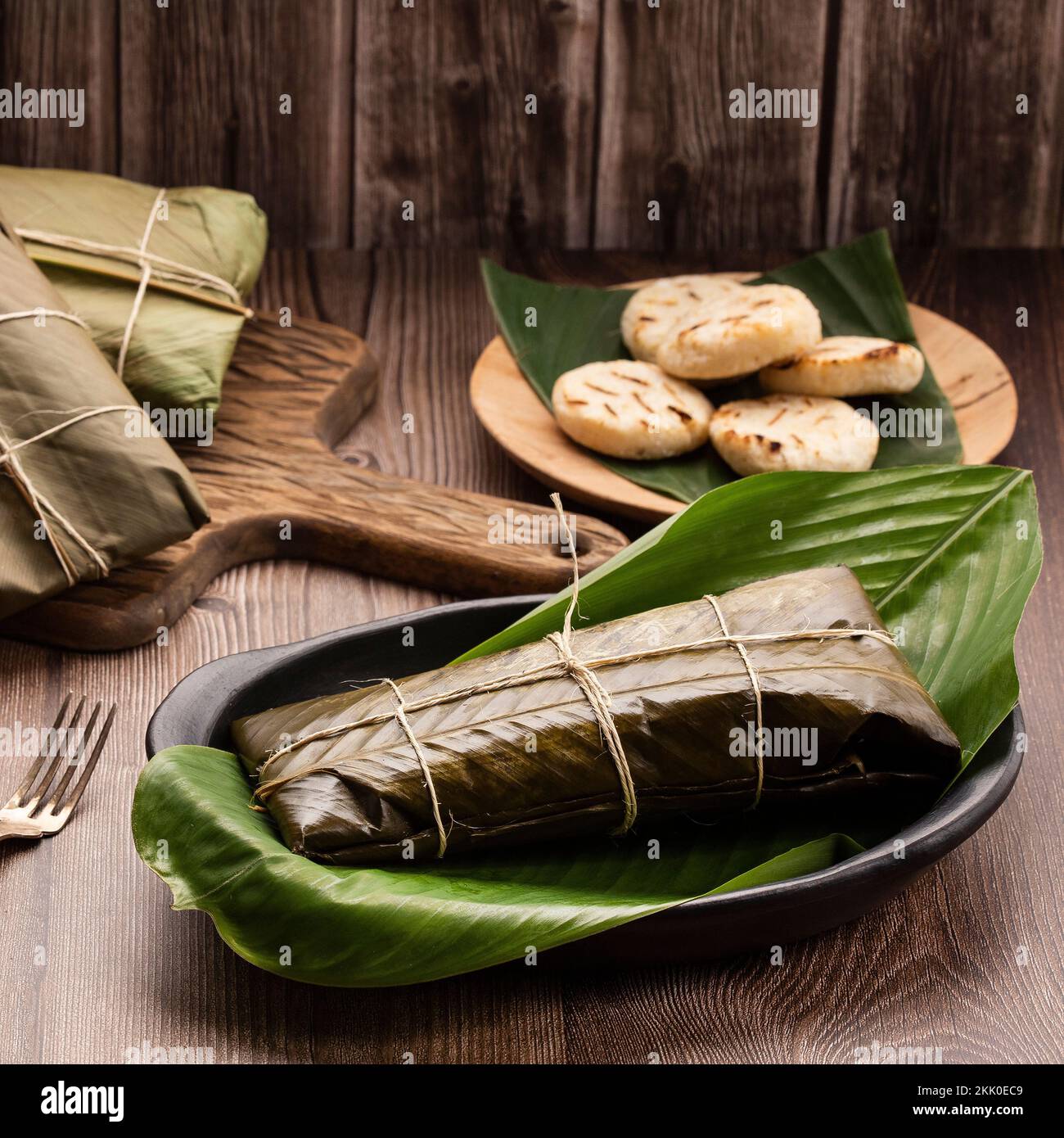 Traditional colombian tamales - Wrapped in green banana leaves Stock