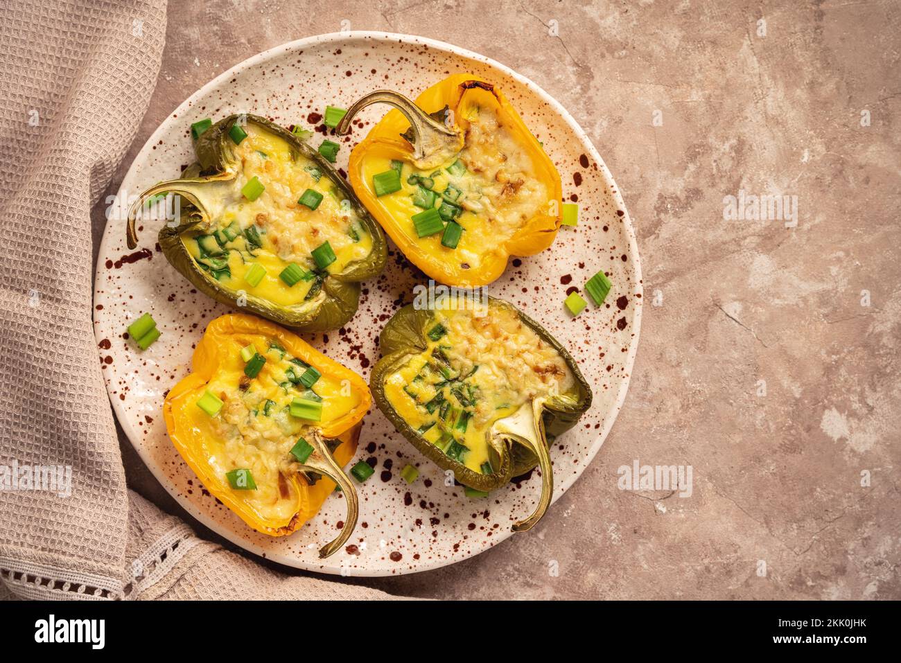 Keto diet dish - pepper stuffed with eggs, cheese and bacon , baked in oven. Stock Photo