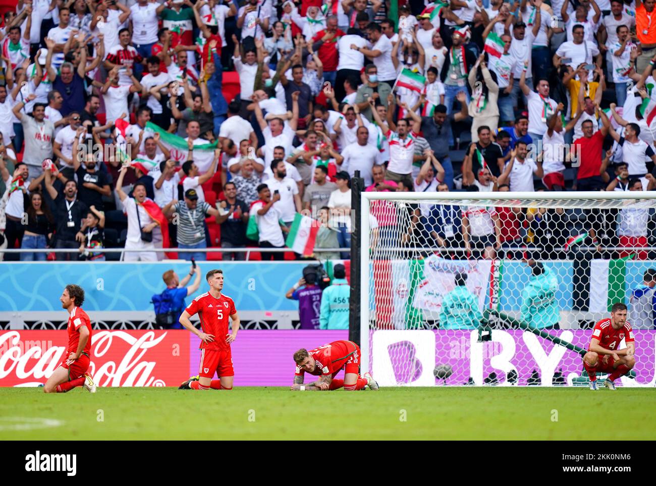 Wales players appear dejected after Iran's Roozbeh Cheshmi (not pictured) scores their side's first goal of the game during the FIFA World Cup Group B match at the Ahmad Bin Ali Stadium, Al-Rayyan. Picture date: Friday November 25, 2022. Stock Photo