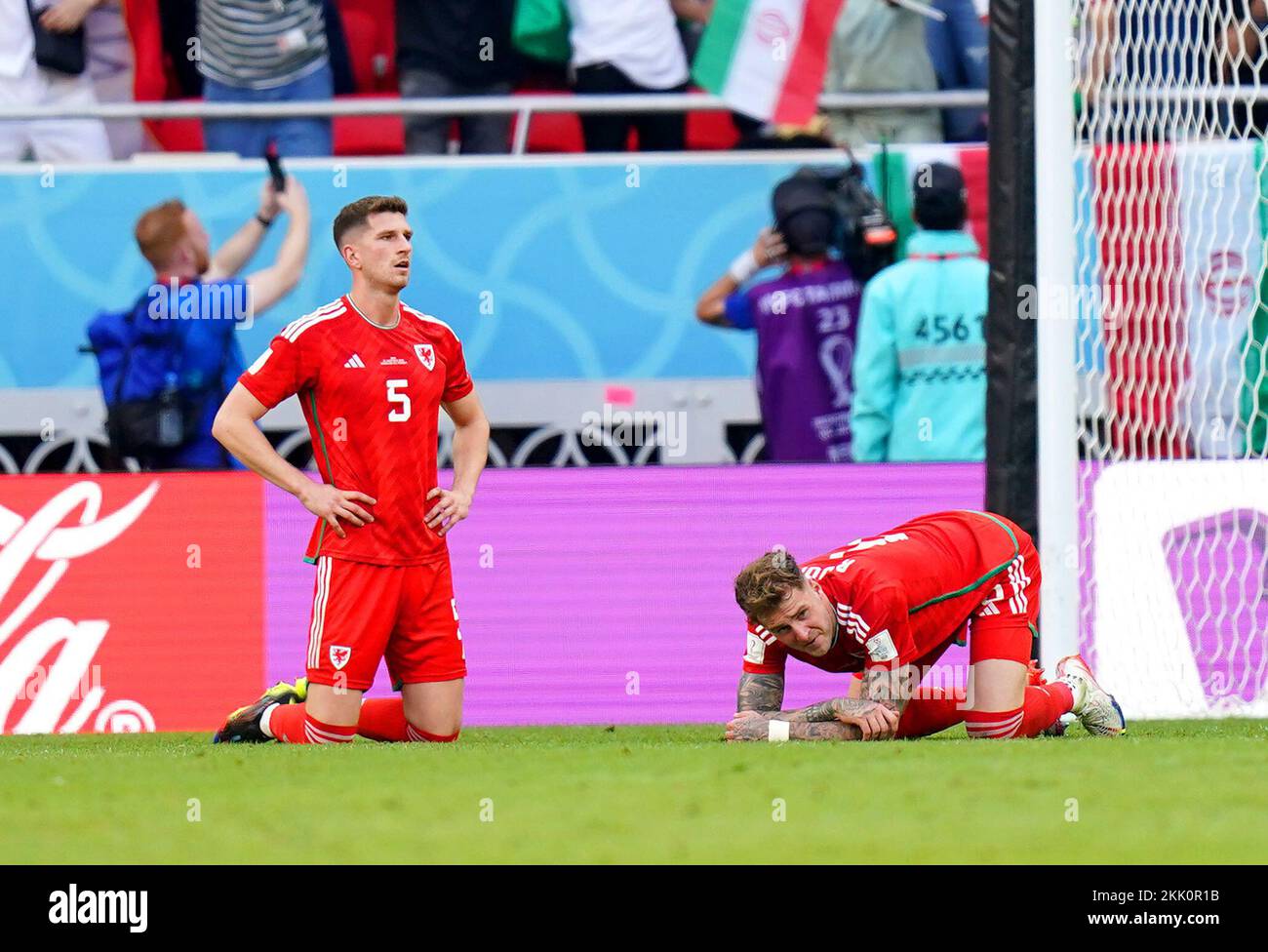 Wales' Chris Mepham (left) and Joe Rodon appear dejected after Iran's Roozbeh Cheshmi (not pictured) scores their side's first goal of the game during the FIFA World Cup Group B match at the Ahmad Bin Ali Stadium, Al-Rayyan. Picture date: Friday November 25, 2022. Stock Photo