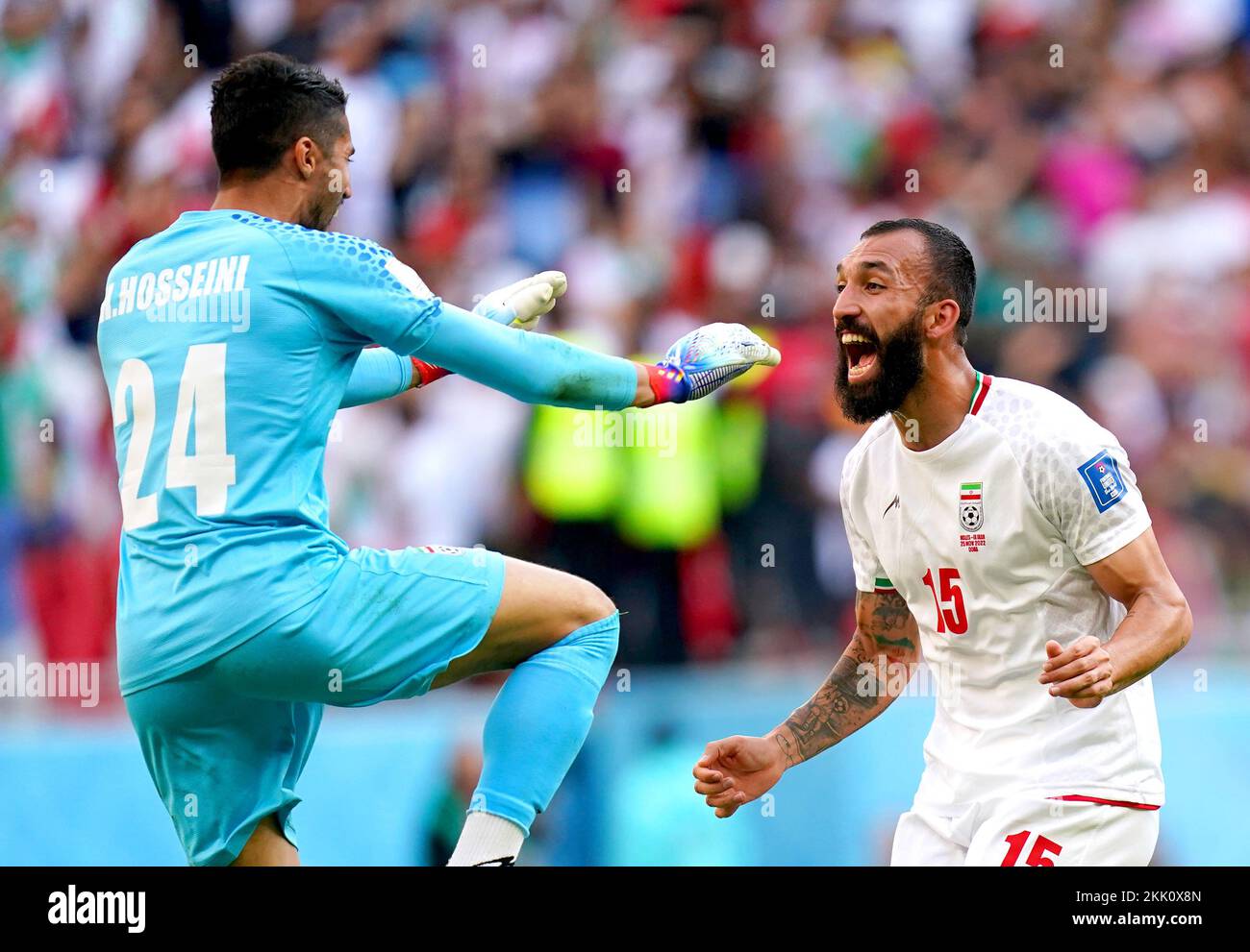 Iran goalkeeper Hossein Hosseini (left) celebrates with Roozbeh Cheshmi at the end of the FIFA World Cup Group B match at the Ahmad Bin Ali Stadium, Al-Rayyan. Picture date: Friday November 25, 2022. Stock Photo