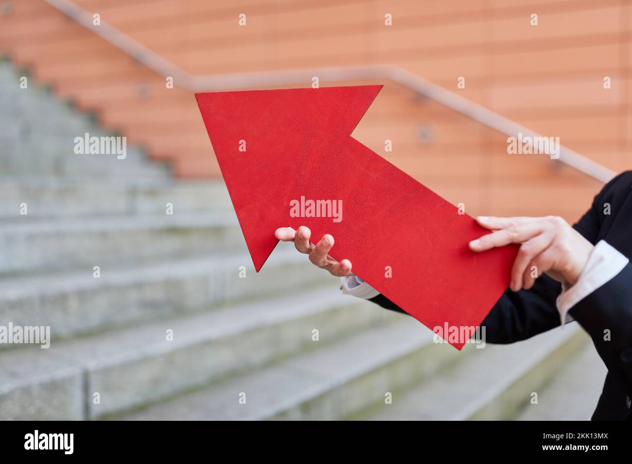 Businesswoman holding ted arrow sign as growth and innovation concept symbol Stock Photo