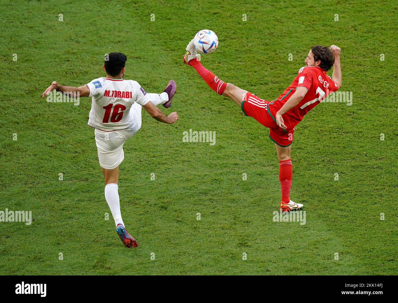 Iran's Mehdi Torabi battles with Wales’ Joe Allen during the FIFA World Cup Group B match at the Ahmad Bin Ali Stadium, Al-Rayyan. Picture date: Friday November 25, 2022. Stock Photo