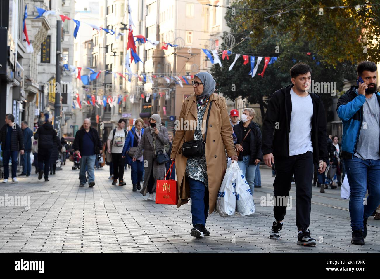 (221125) -- ISTANBUL, Nov. 25, 2022 (Xinhua) -- Pedestrians walk on the Istiklal Avenue in Istanbul, T¨¹rkiye, Nov. 22, 2022.  Days after the bloody explosion that rocked the busiest pedestrian avenue in Istanbul, additional security measures have been taken with a heavy presence of police patrolling the area.    The Istiklal Avenue, lined with stores of famous brands, cafes, and bars, is flooded with people as usual. 'Many additional security measures have been taken since the bomb explosion,' Haydar Ali Yildiz, mayor of Beyoglu district, told reporters on Tuesday.   On Nov. 13, six people we Stock Photo