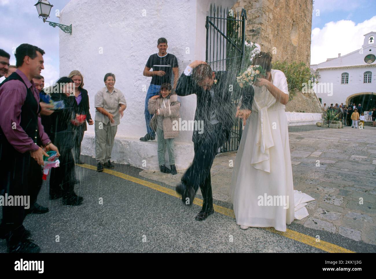 Monte Toro Menorca Balearic Islands Spain Bride and Groom Outside Church after Wedding Guests Throwing Rice Stock Photo