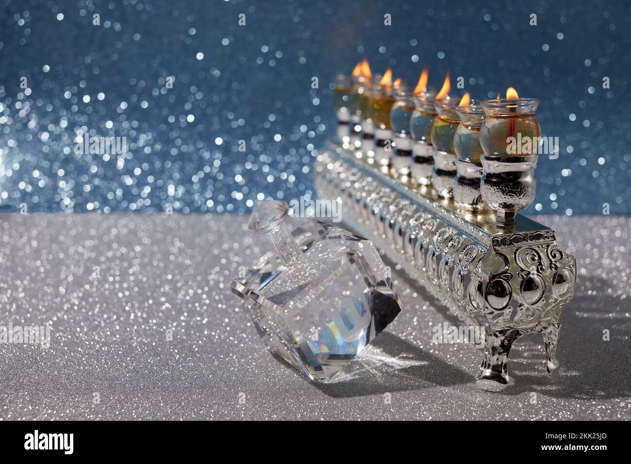 Jewish holiday Hanukkah background with oil menorah and dreidel with