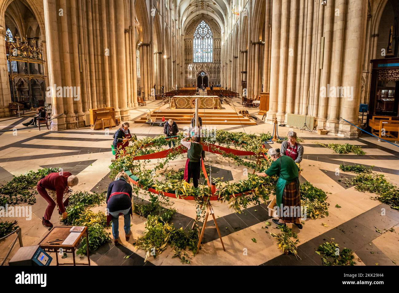 Finishing touches are made to the Advent wreath before it is raised to its traditional position below the Central Tower at York Minster. Picture date: Friday November 25, 2022. Stock Photo