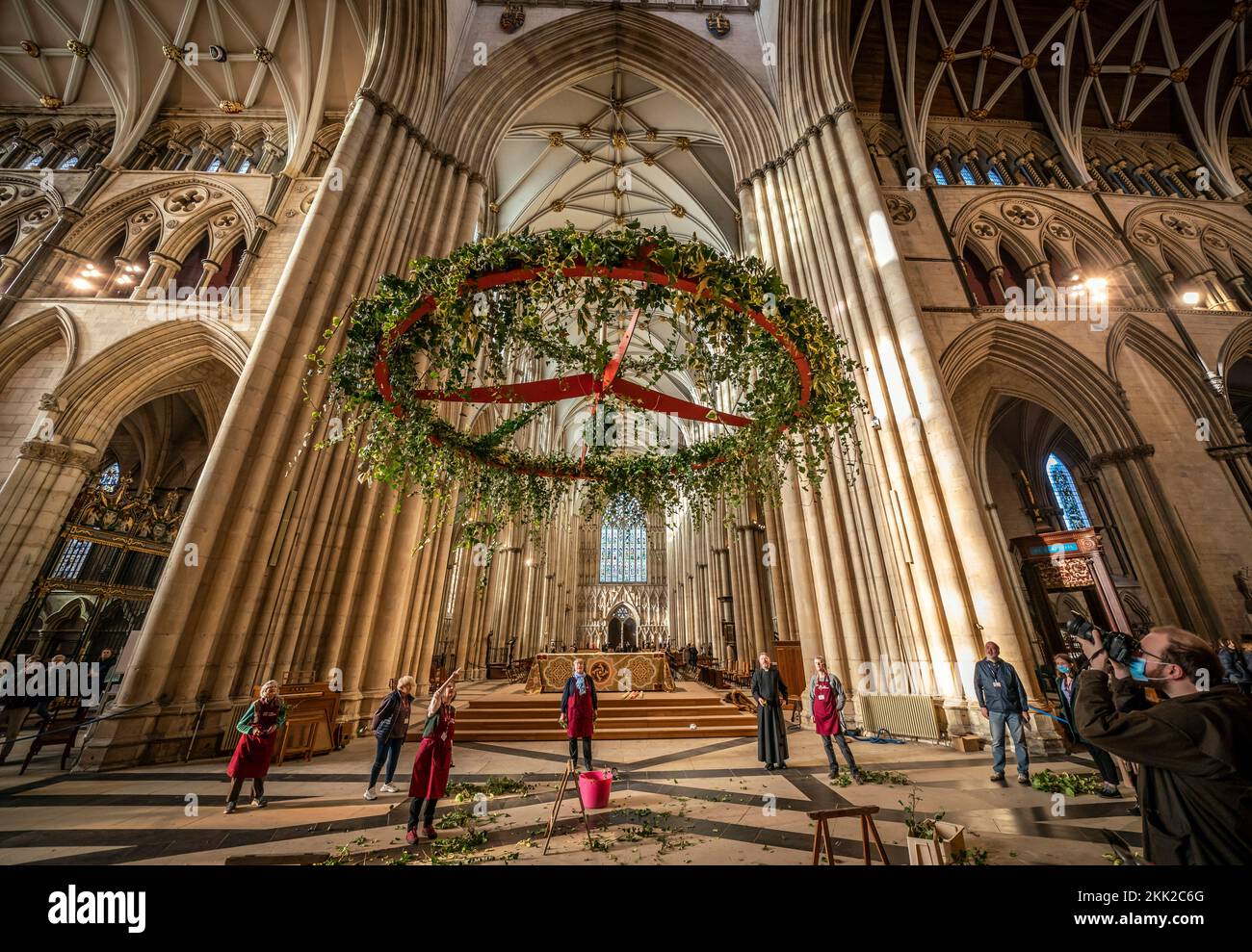 People watch on as the Advent wreath is raised to its traditional position below the Central Tower at York Minster. Picture date: Friday November 25, 2022. Stock Photo