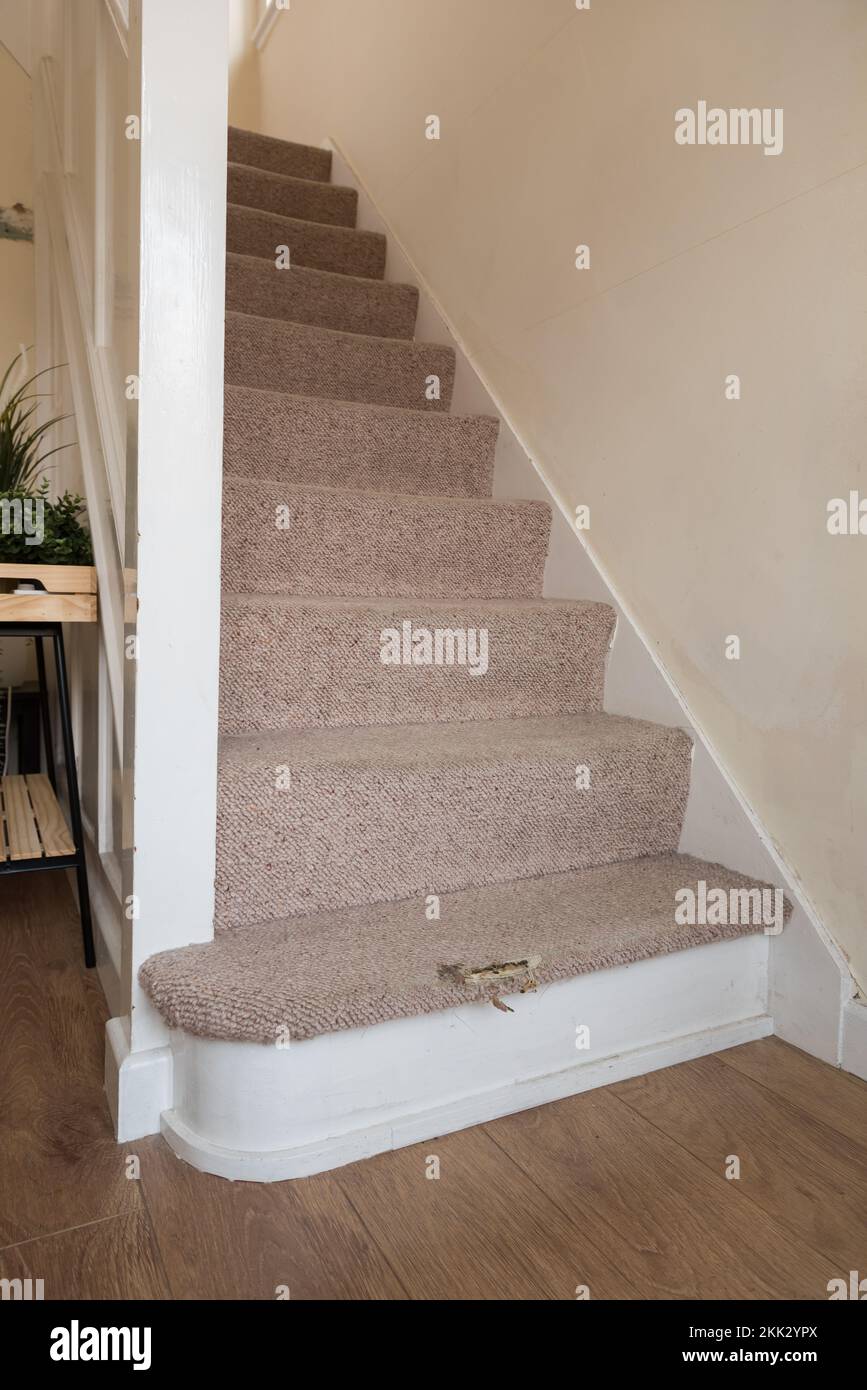 Risk of injury due to tripping or slipping on worn carpet on stairs