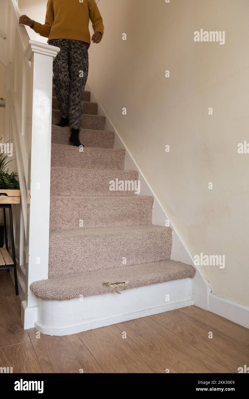 Risk of injury due to tripping or slipping on worn carpet on stairs