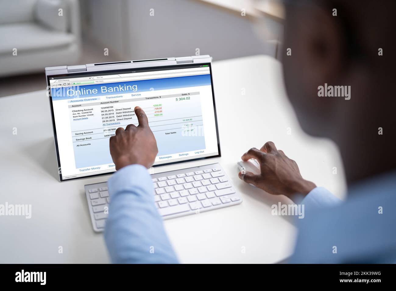 Young Happy African Businessman Doing Online Banking On Computer At Office Stock Photo