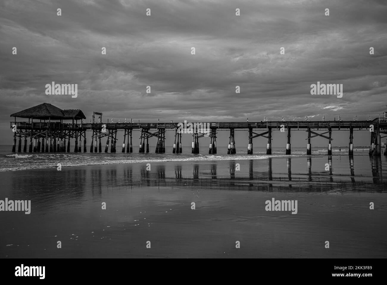 A grayscale of the Cocoa Beach pier surrounded by seascape in Florida