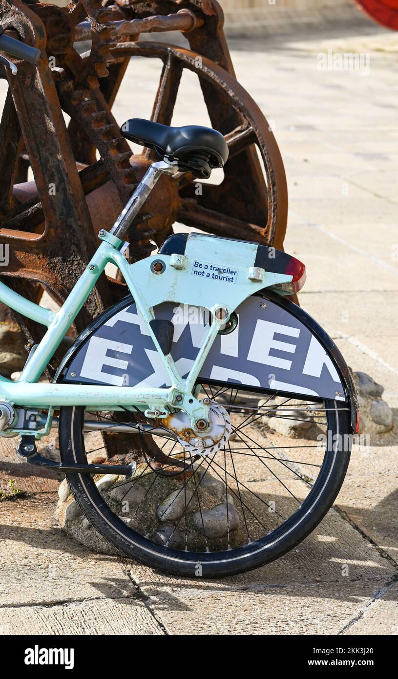 Be a Traveller Not a Tourist slogan on an abandoned bicycle in, Sussex , England UK  Photograph taken by Simon Dack Stock Photo