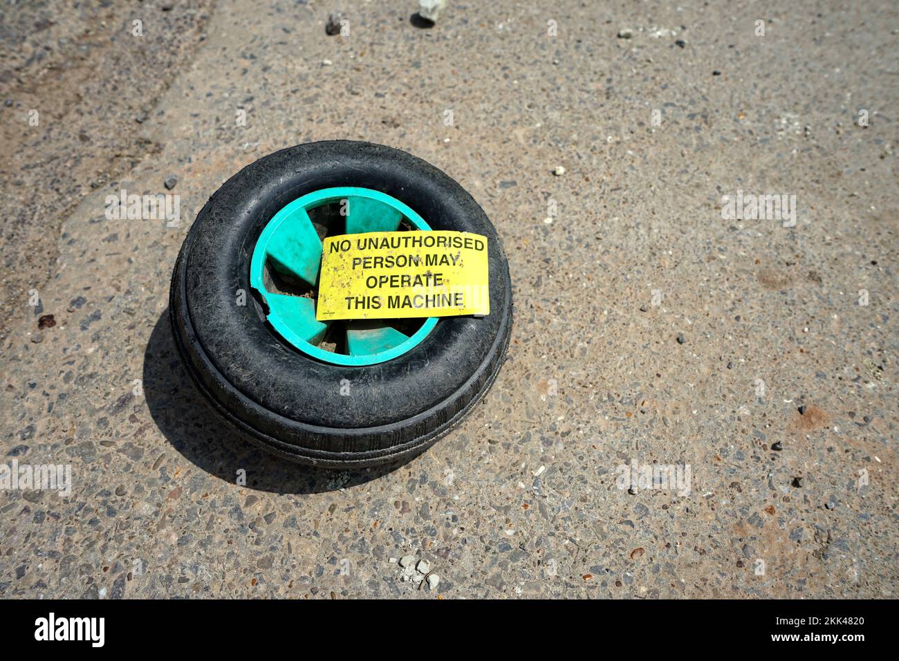 An old wheel with a sign on Stock Photo