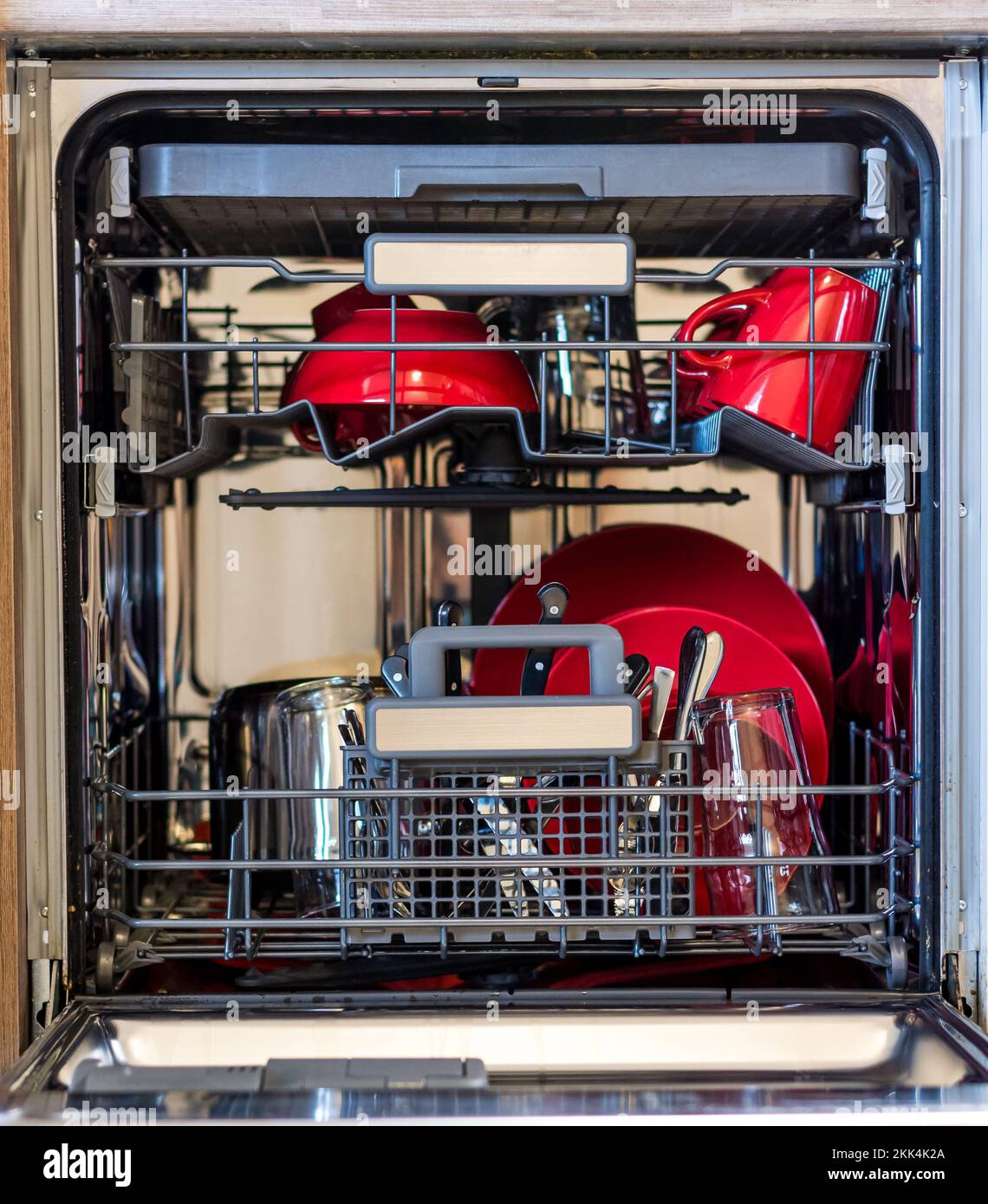 Look into dishwasher with the clean dish. Clean plate placed in kitchen cleaning machine Stock Photo