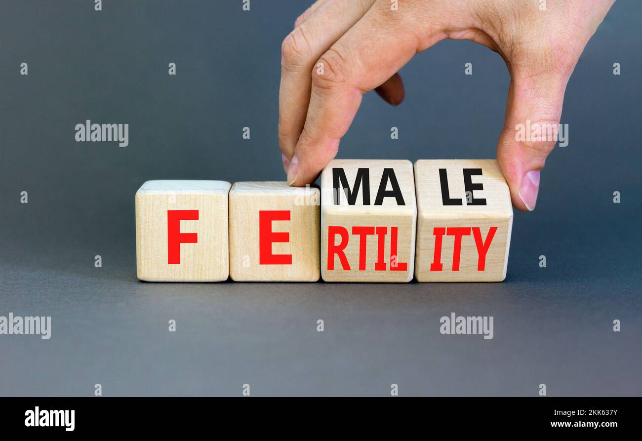 Female fertility symbol. Concept word Female fertility on wooden cubes