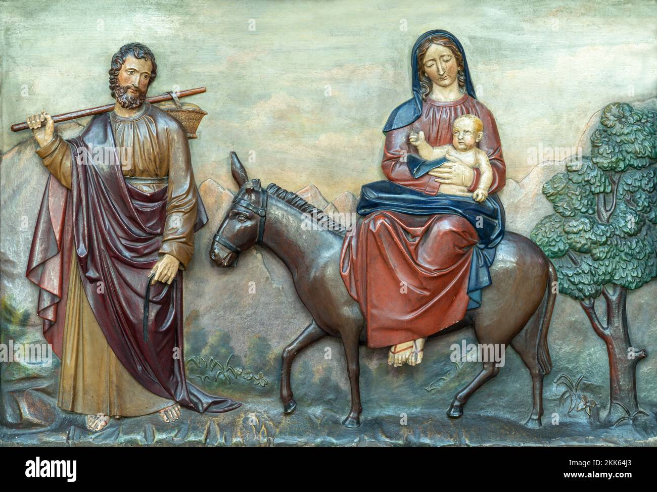 ANNECY, FRANCE - JULY 11, 2022: The  carved polychrome relief of Flight to Egypt in St. Pierre Cathedral by unknown artist. Stock Photo
