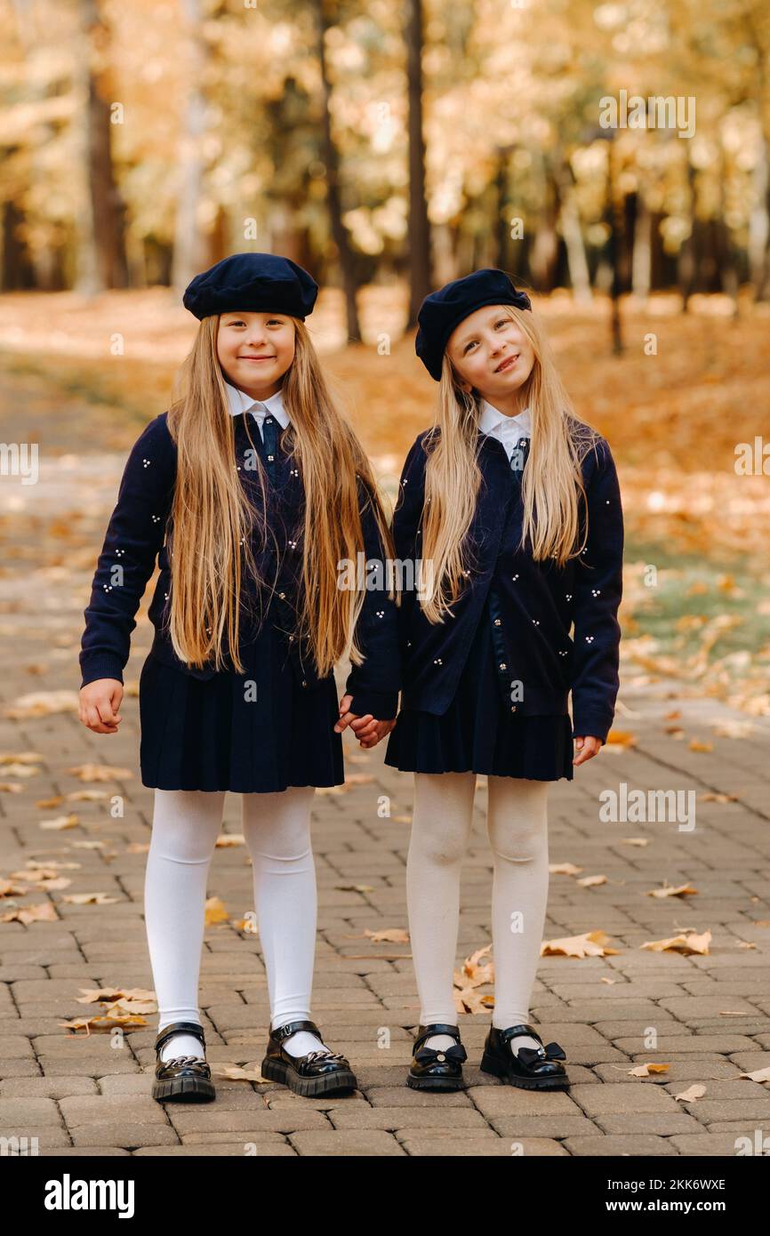Happy children holding hands in a beautiful autumn park Stock Photo - Alamy