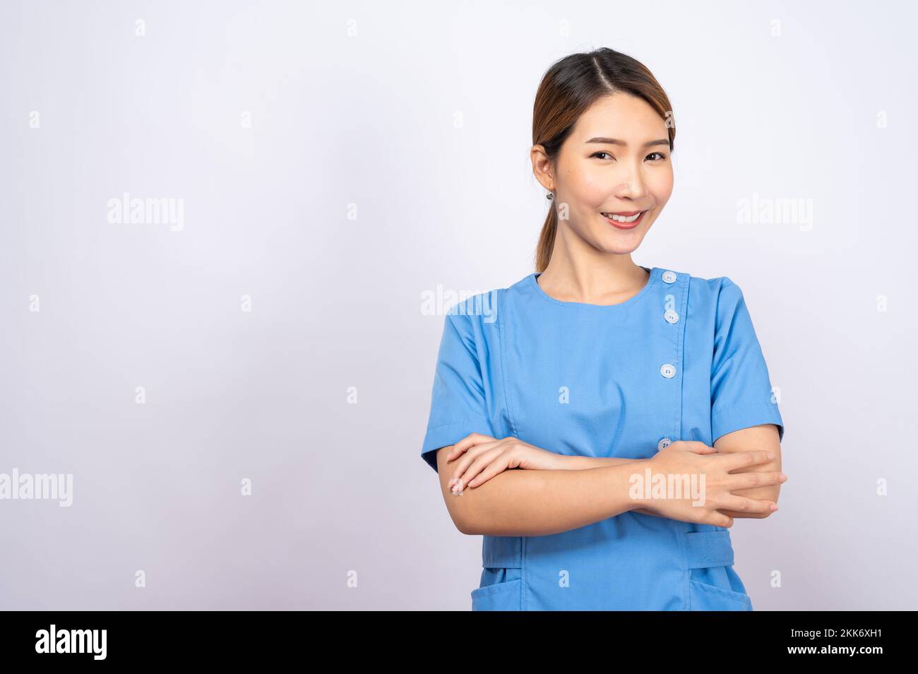 A portrait of a young Asian nurse on white background Stock Photo - Alamy