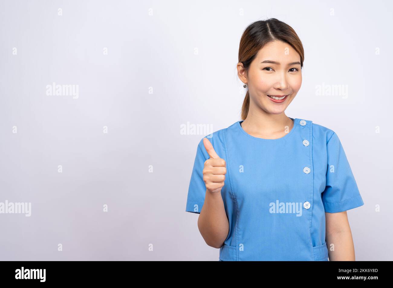 A portrait of a young Asian nurse on white background Stock Photo - Alamy