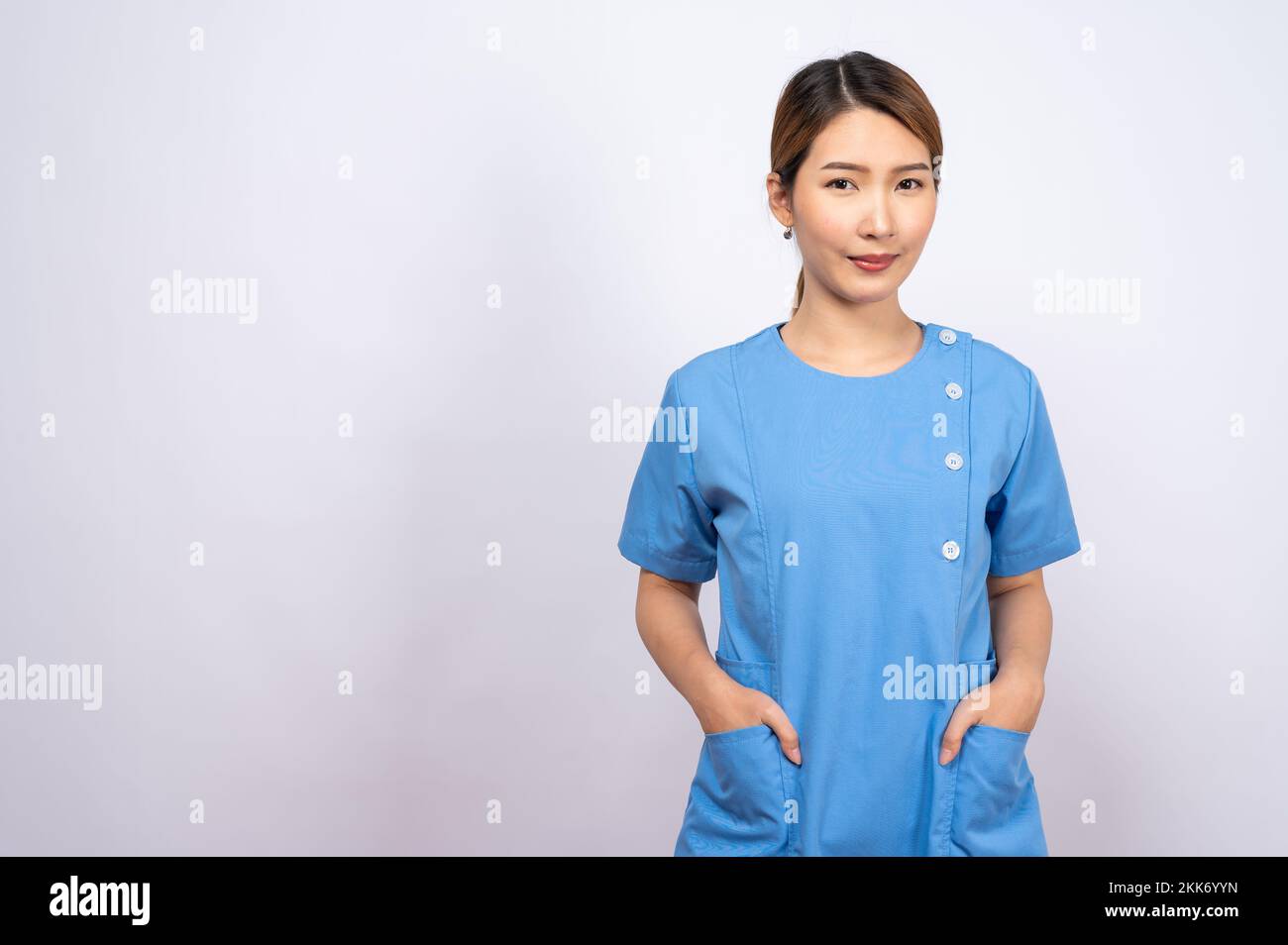 A portrait of a young Asian nurse on white background Stock Photo - Alamy