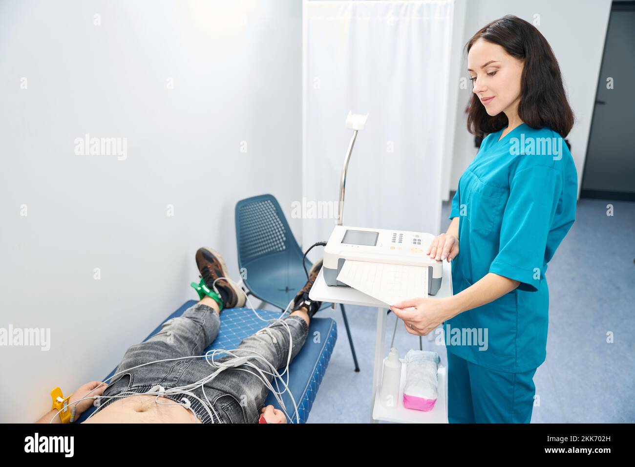 Nurse receives printout of results of heart from the cardiograph Stock Photo
