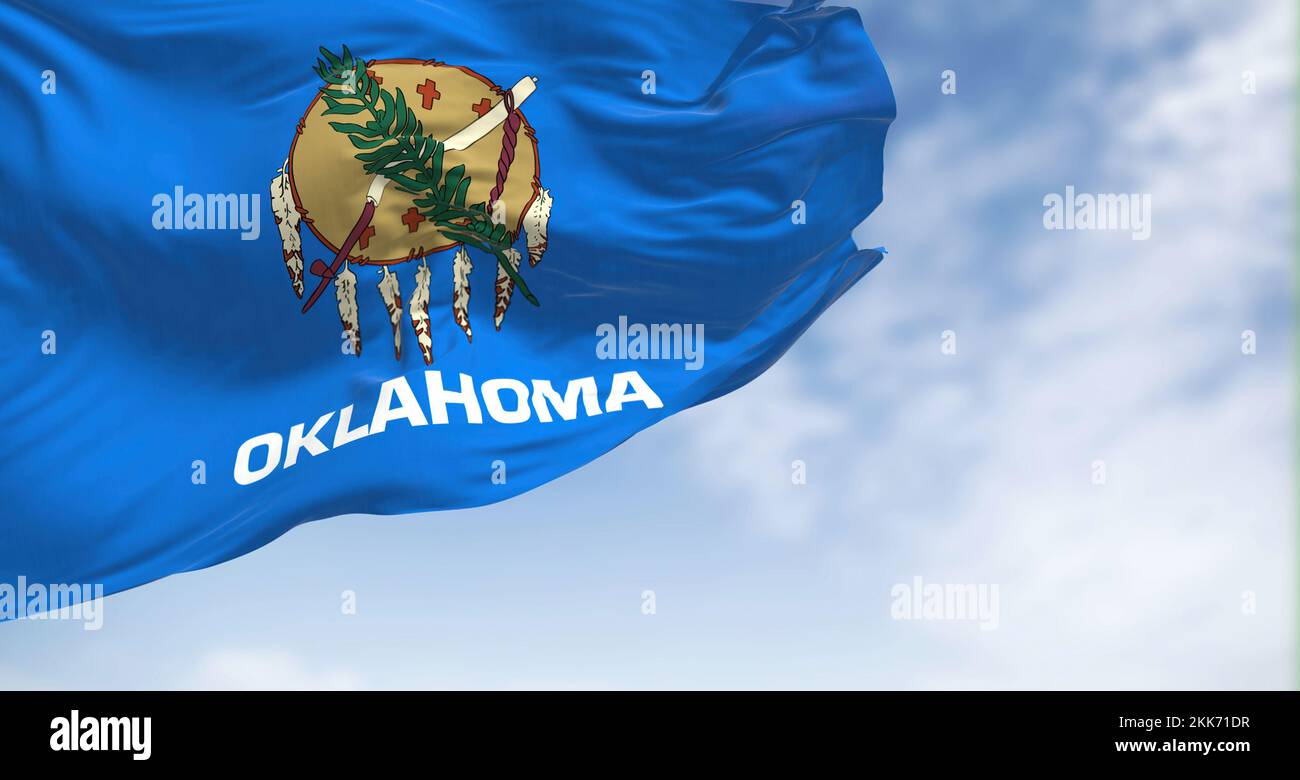 Close up view of the Oklahoma state flag waving. Oklahoma is a state in the South Central region of the United States. Fabric textured background. Sel Stock Photo