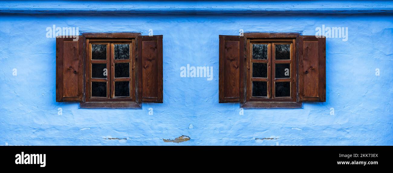 a blue clay house with old wooden windows Stock Photo - Alamy