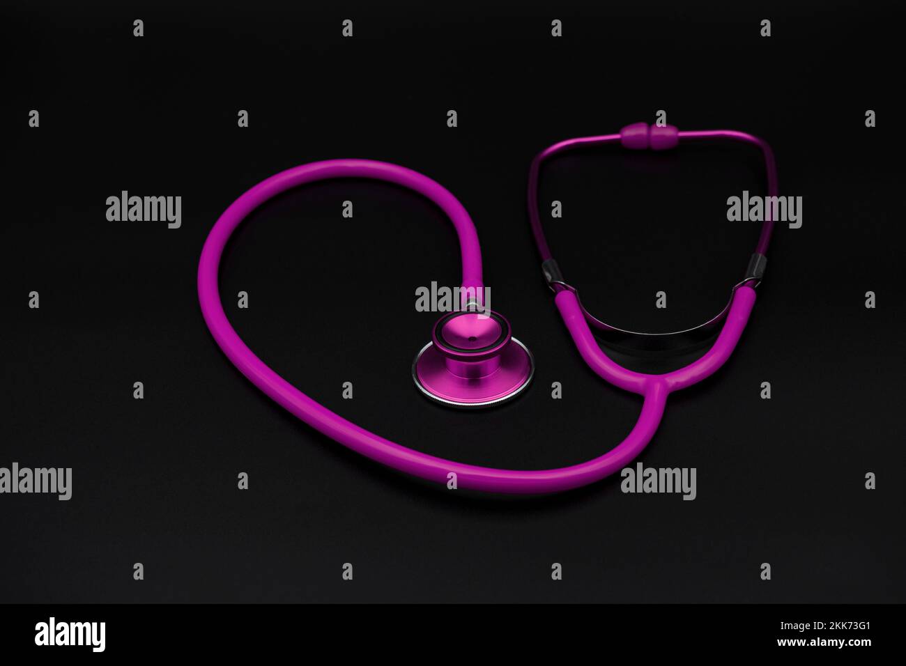 pink stethoscope on dark background Stock Photo - Alamy