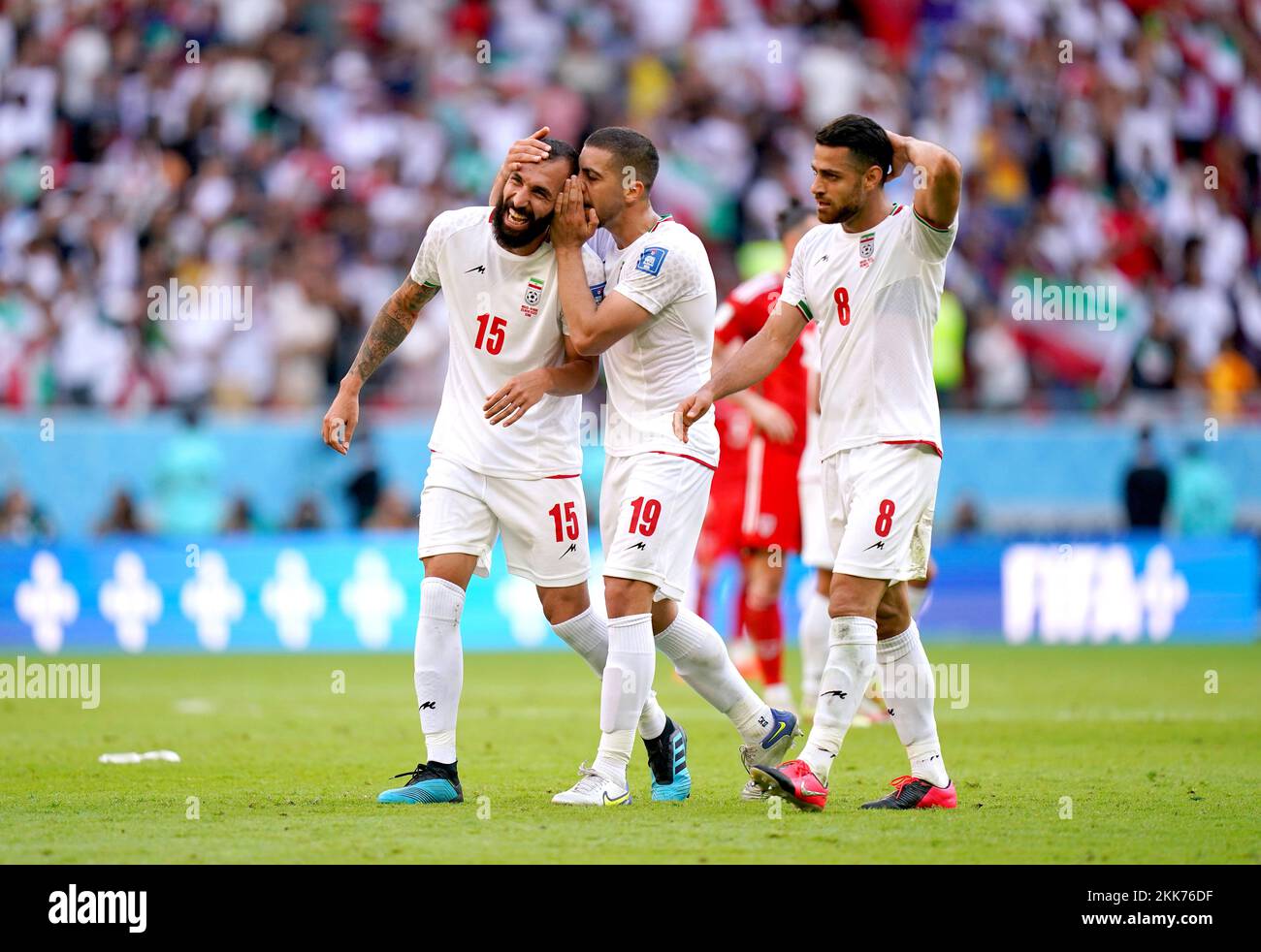 Iran's Roozbeh Cheshmi (left), Majid Hosseini and Morteza Pouraliganji celebrate at the end of the FIFA World Cup Group B match at the Ahmad Bin Ali Stadium, Al-Rayyan. Picture date: Friday November 25, 2022. Stock Photo