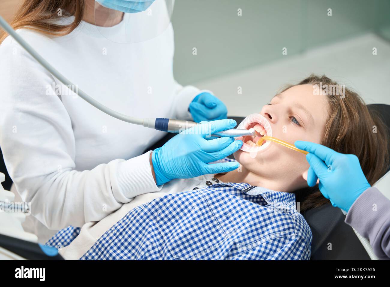 Young patient treats tooth at a dentist in medical institution Stock Photo