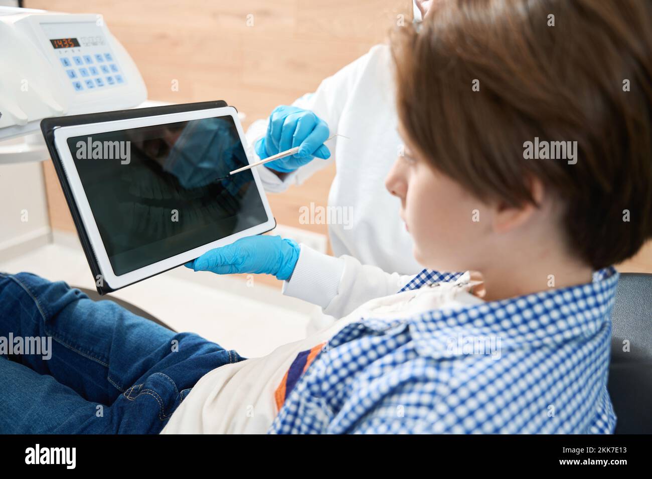 Dentist consulting a young patient in the dental office Stock Photo
