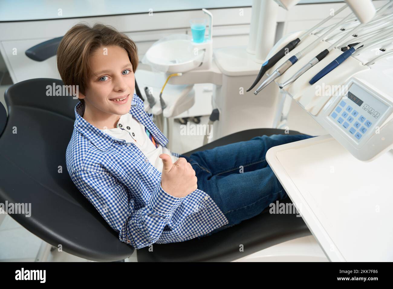 Smiling child sits in the dental chair Stock Photo