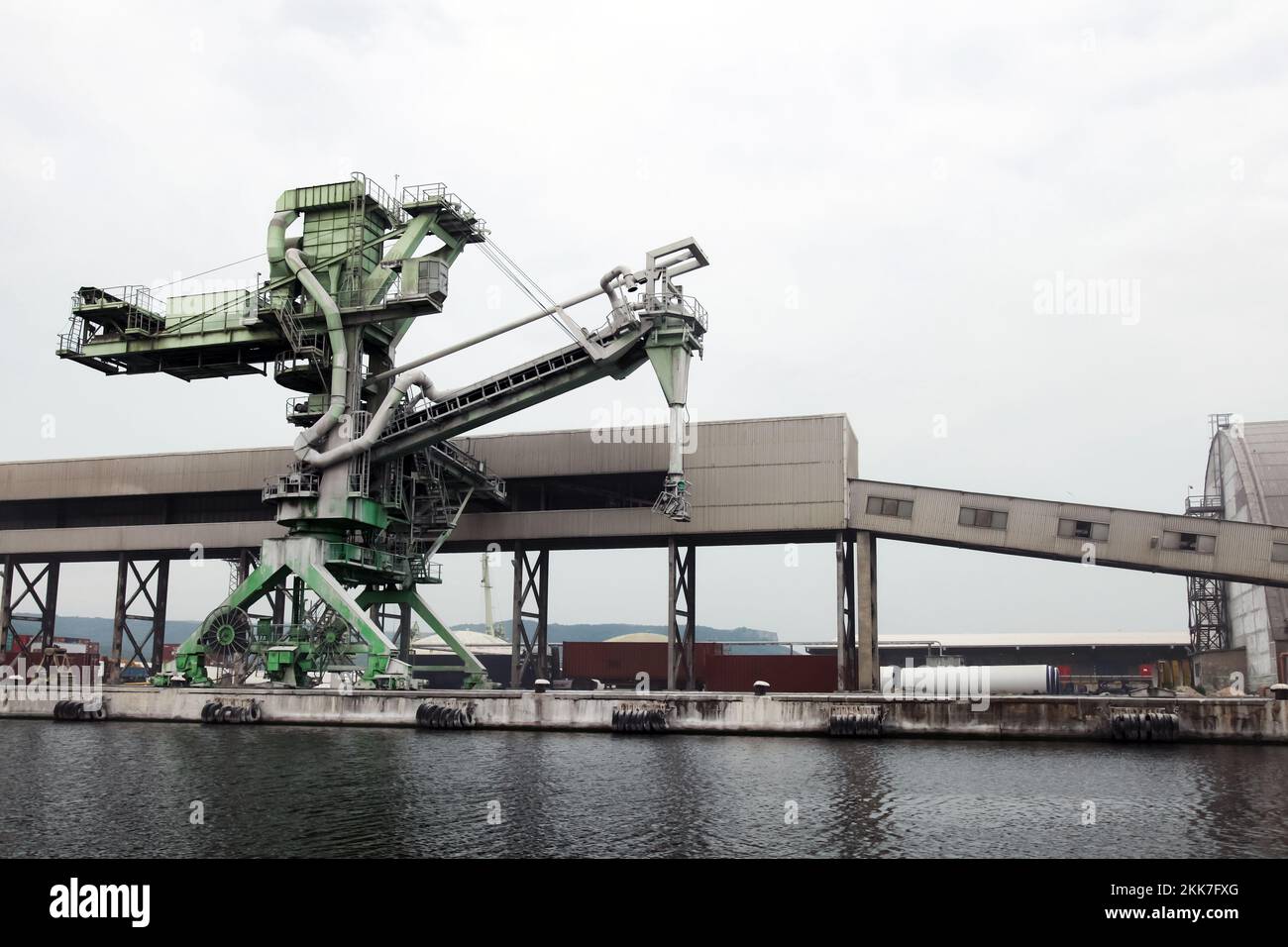 Green port crane for bulk products is near the transporter at Sea port of Varna, Bulgaria Stock Photo