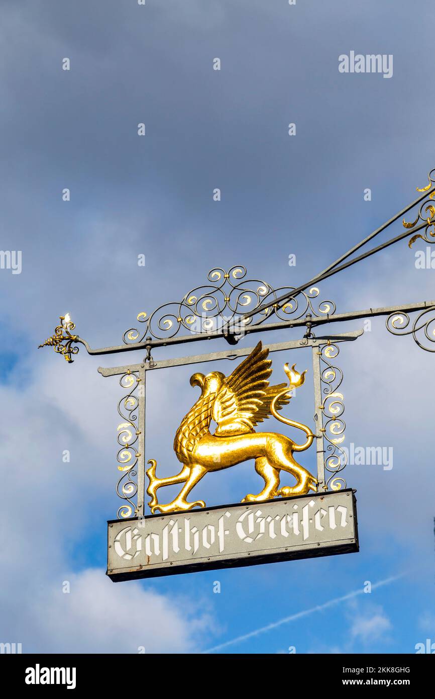 Rothenburg ob der Tauber, Germany - January 15, 2014: Medieval shop signage Gasthof Greifen engl: restaurant griffon , with griffon in gold symbolizin Stock Photo