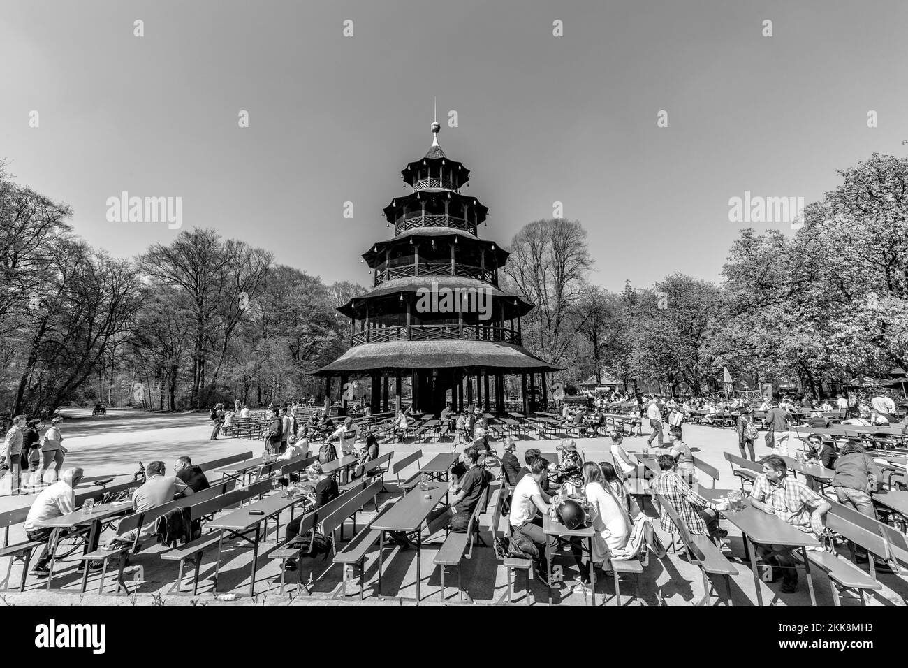 Munich, Germany - April 20, 2015: people enjoy the  Biergarten near Chinese tower in English garden in Munich, Bavaria, Germany. Stock Photo