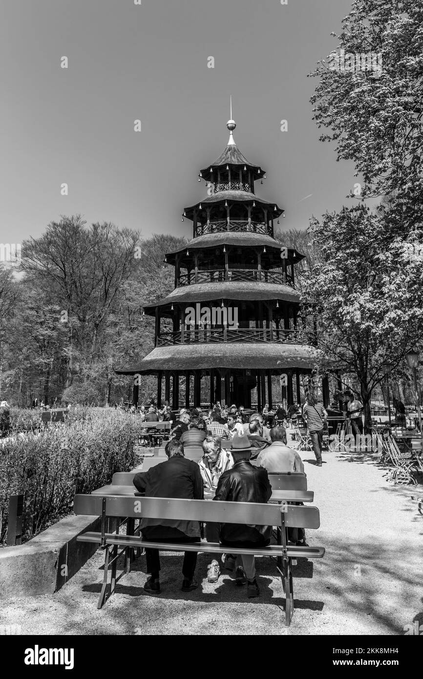 Munich, Germany - April 20, 2015: people enjoy the  Biergarten near Chinese tower in English garden in Munich, Bayern, Germany. Stock Photo