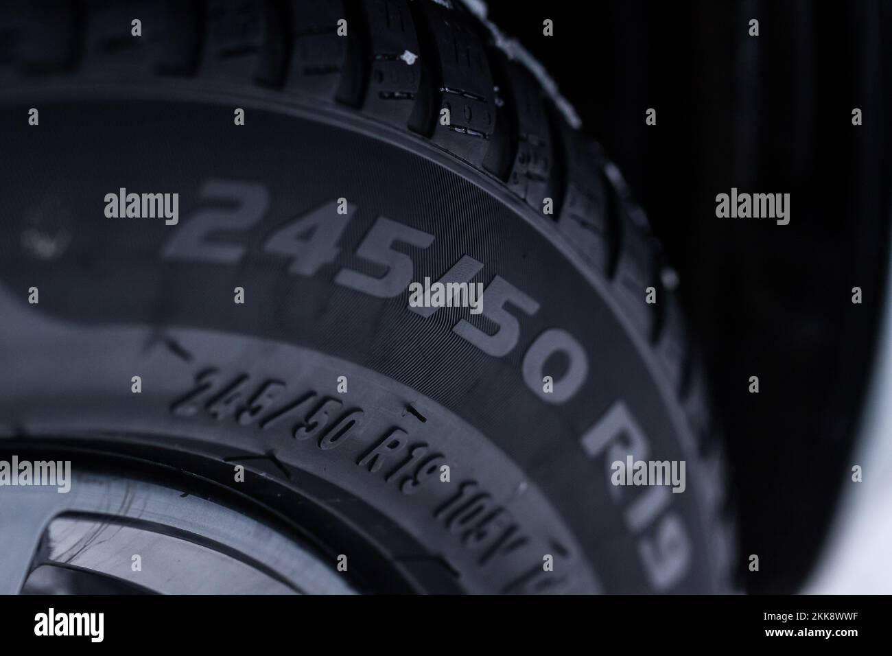 Close up view of snowy tire with tire width, height and wheel diameter