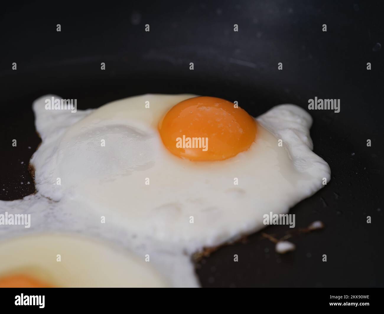 Two fried eggs in a frying pan. Close up. Stock Photo