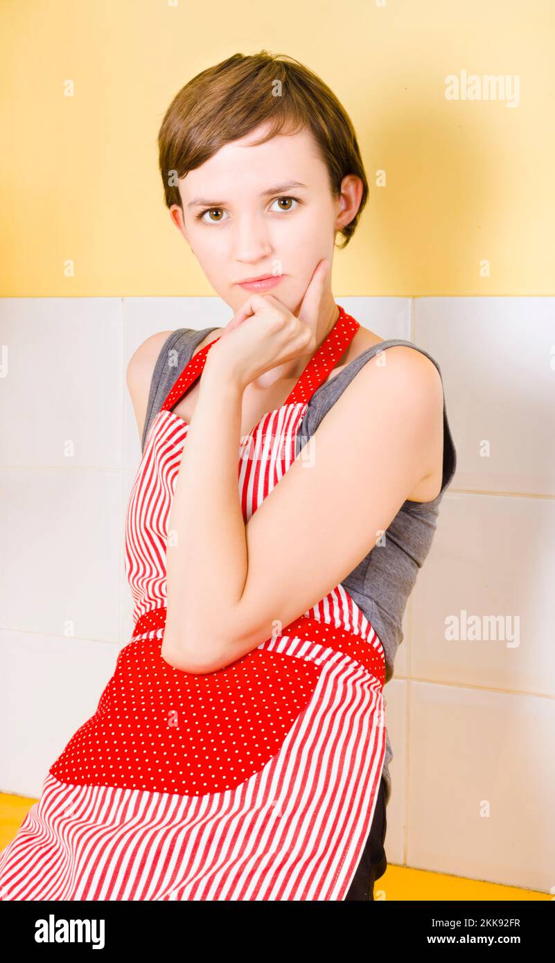 Portrait of a serious female chief sitting on a bakery bench thinking Stock Photo